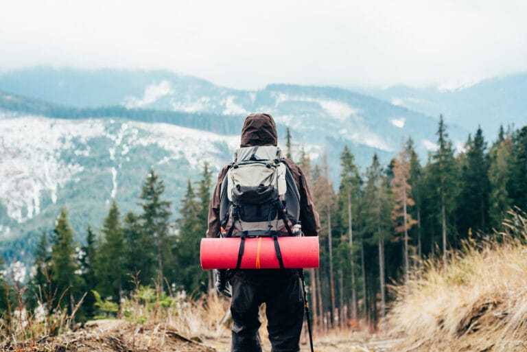 caucasian male hiking in mountains